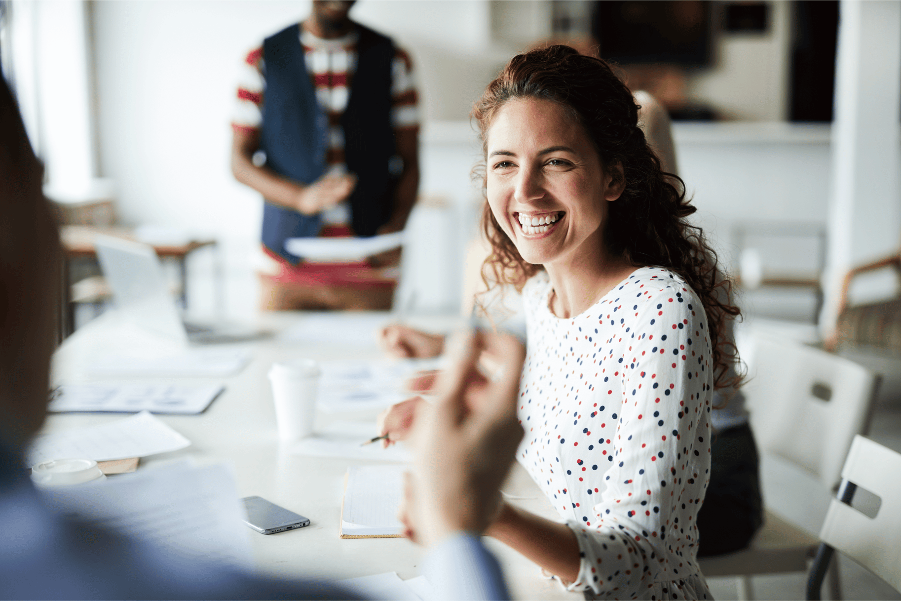 Person in a meeting smiling