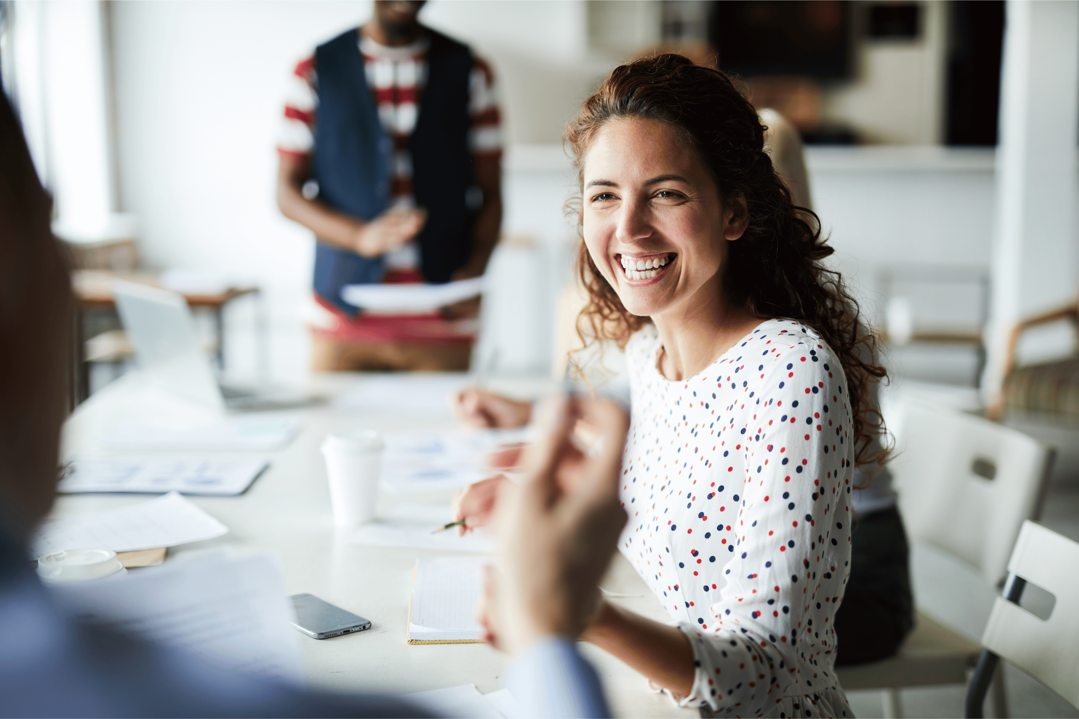Person in a meeting smiling