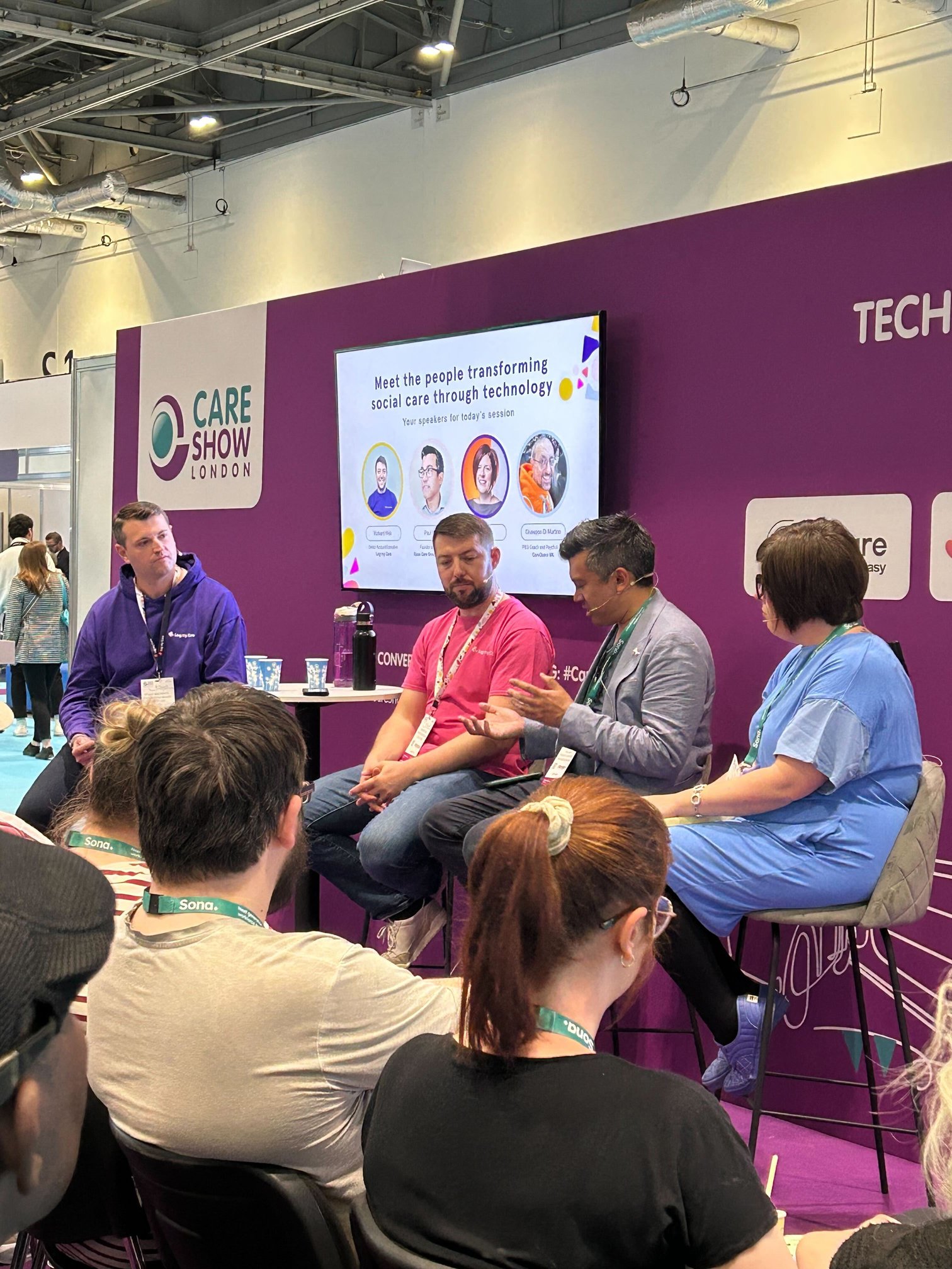 Care Show London 2025 speaker panel, 4 speakers sat on stools in front of audience