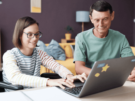 Person with support worker looking at laptop