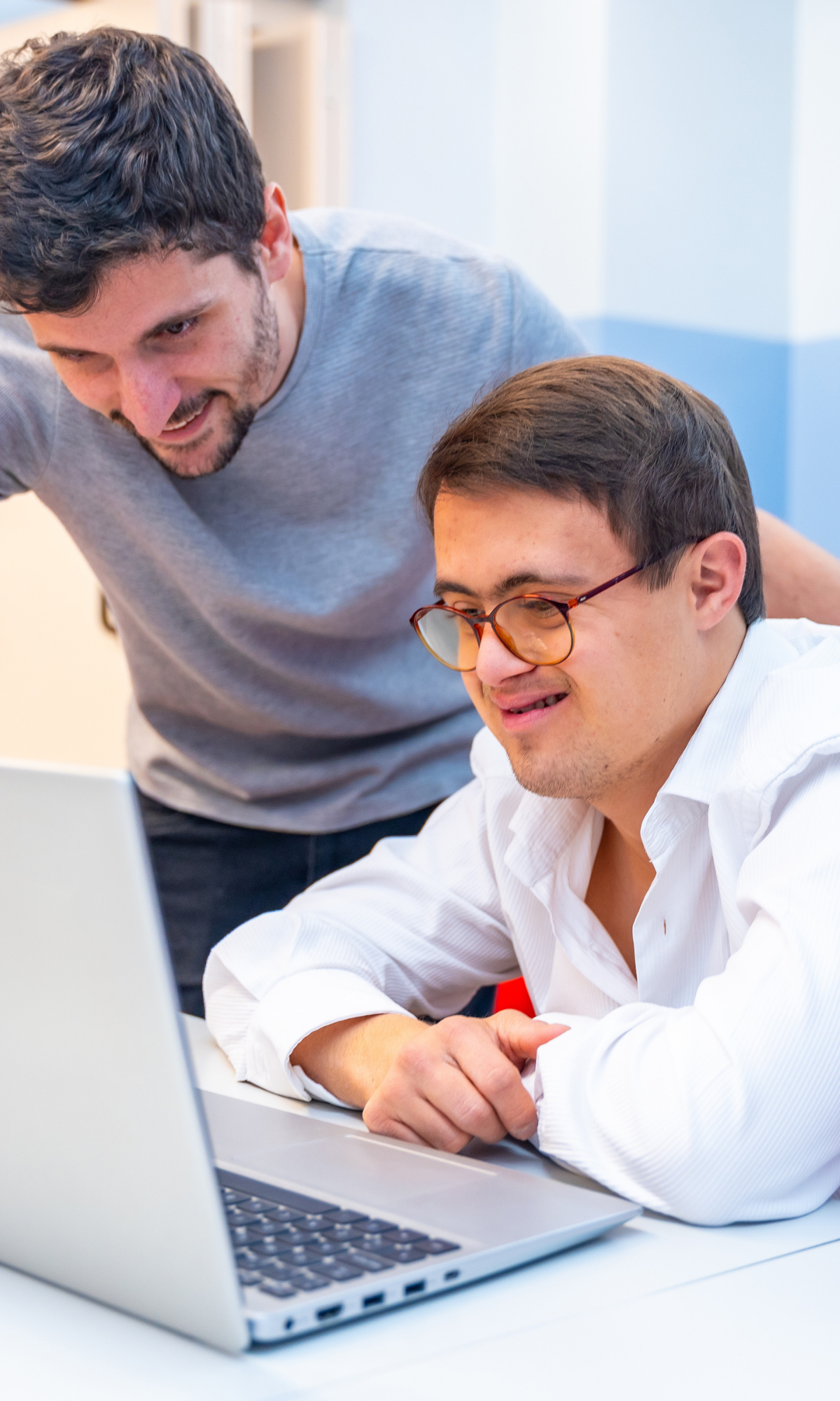 Service user and caregiver looking at laptop