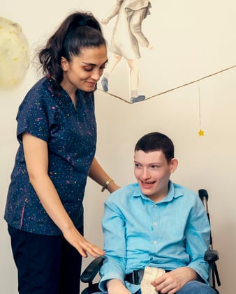 Support worker helping person in a wheelchair