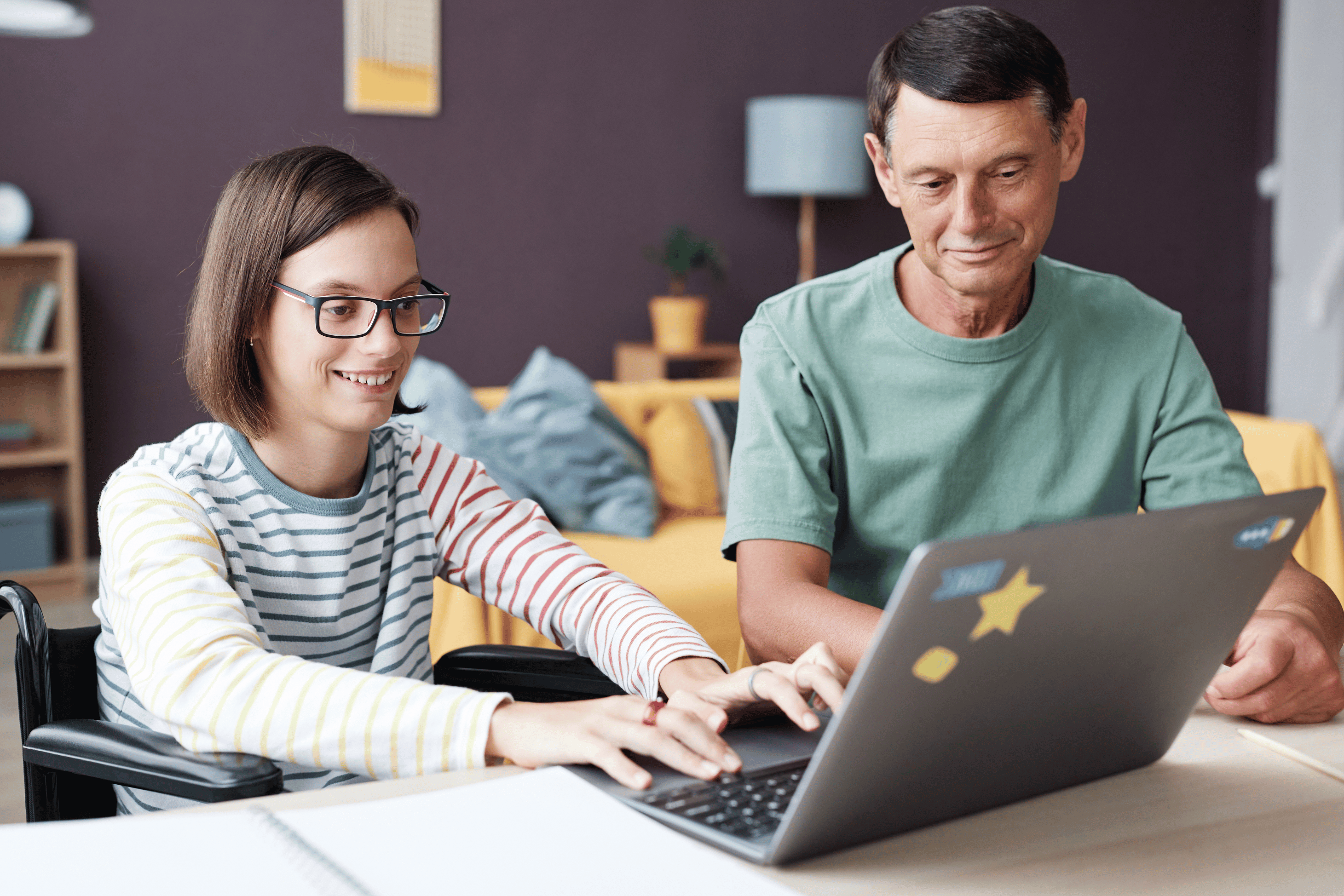 person-in-wheelchair-using-laptop-with-support-worker