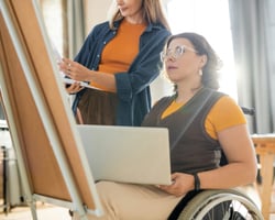 support worker helping a person paint-1