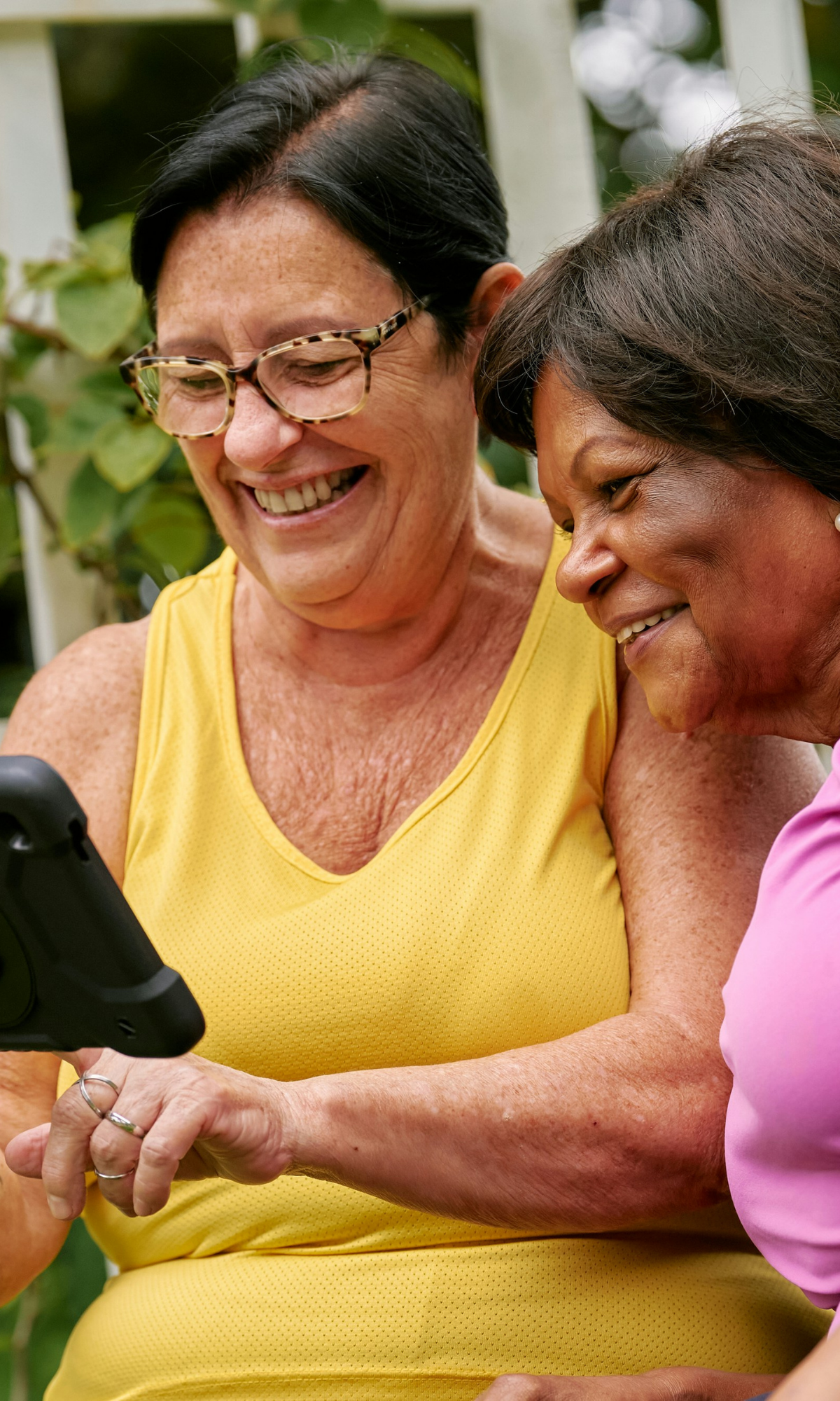 two women looking at ipad smiling