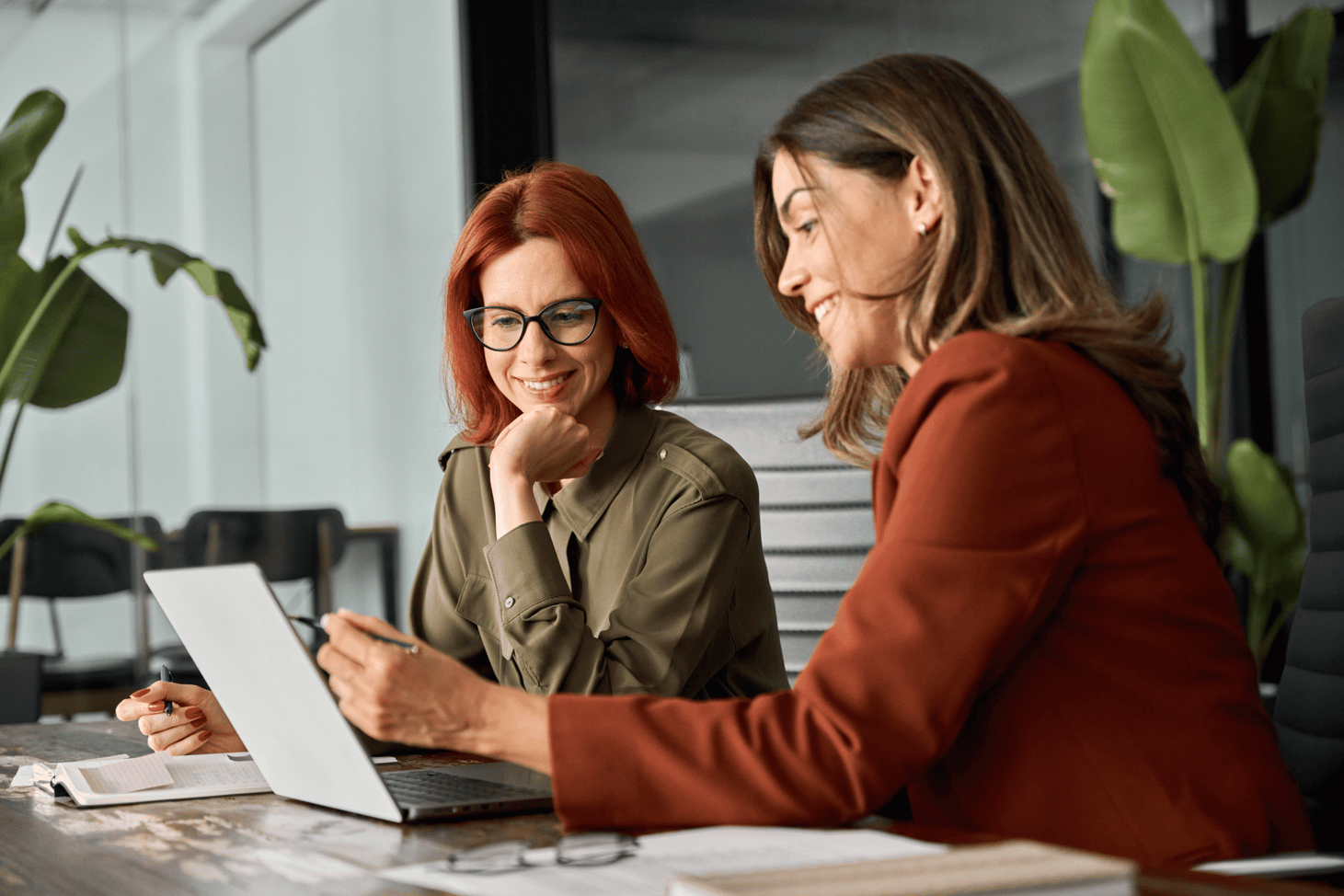 two-people-smiling-looking-at-laptop-screen